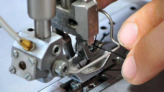 Einfädeln eines schwerentflammbaren Fadens zum Vernähen der Bezüge für Privatflugzeuge.